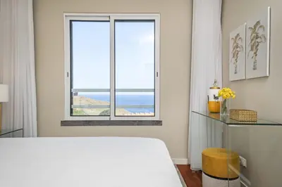 a bedroom with a bed and a window at Hideaway Apartment by Homie in Caniço