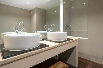 a bathroom with two sinks and a mirror at By the Atlantic Apartments 3-bedroom in Funchal