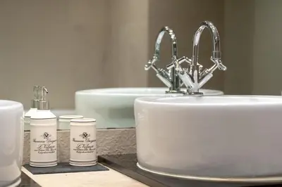 a bathroom sink with two bottles ofodorizers and a sink at By the Atlantic Apartments 3-bedroom in Funchal