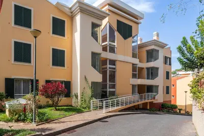 an apartment building with a staircase in a street at Vista Formosa I by An Island Apart in Funchal