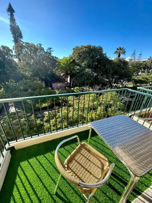 a table and a chair on a balcony at Santa Catarina by Olá Madeira in Funchal
