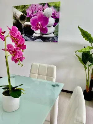 a white dining room table with pink flowers on it at Santa Catarina by Olá Madeira in Funchal