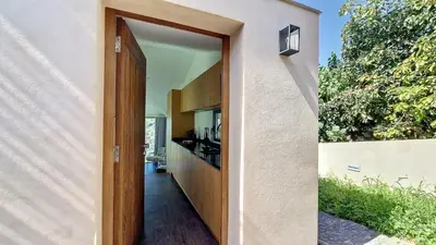 a door leading to a kitchen in a house at Serenity Valley Escape by LovelyStay in Ribeira Brava