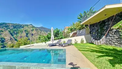 a swimming pool in the backyard of a house at Serenity Valley Escape by LovelyStay in Ribeira Brava