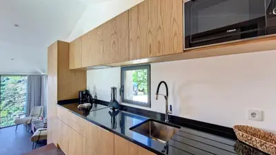 a kitchen with a sink and a microwave at Serenity Valley Escape by LovelyStay in Ribeira Brava