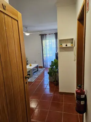 a room with a door and a tile floor at Apartamento Costa Norte in Porto Moniz