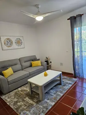 a living room with a couch and a coffee table at Apartamento Costa Norte in Porto Moniz