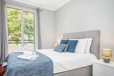 a bedroom with a large bed and a window at Barreiros Serenity by Homie in Funchal