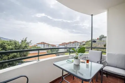 a balcony with a table and chairs and a view at Barreiros Serenity by Homie in Funchal
