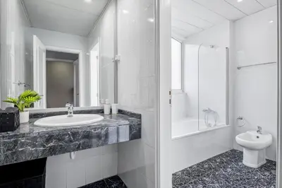 a white bathroom with a sink and a toilet at Barreiros Serenity by Homie in Funchal