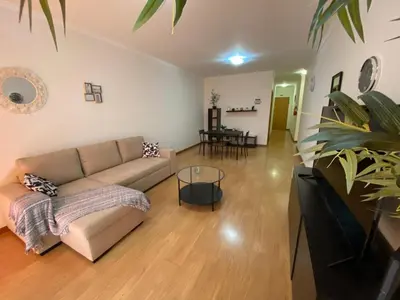 a living room with a couch and a table at Milagrosa Apartment in Caniço