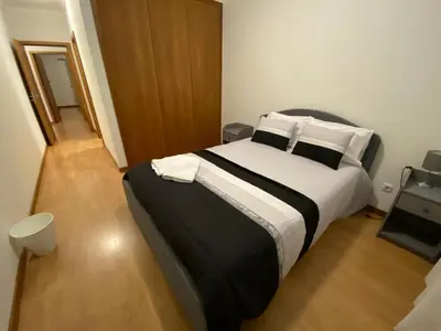 a bedroom with a large bed with white pillows at Milagrosa Apartment in Caniço