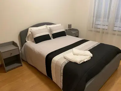 a bedroom with a large bed with two towels on it at Milagrosa Apartment in Caniço