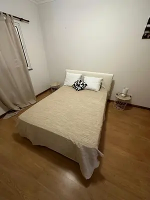 a bedroom with a bed with two pillows on it at Milagrosa Apartment in Caniço