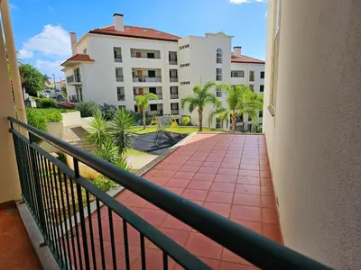 a balcony with a walkway in front of a building at Milagrosa Apartment in Caniço