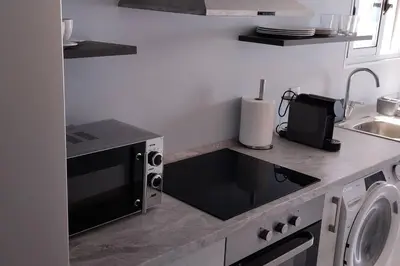 a kitchen with a sink and a microwave at Apt. 'A Bicuda' by The Cliff Coast Accomodation in Paul do Mar