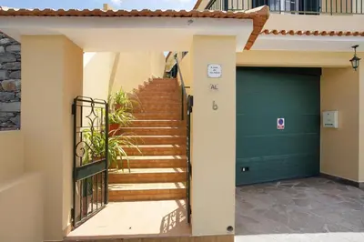 a staircase leading to a house with a green door at Casa do tio Inácio in Santana