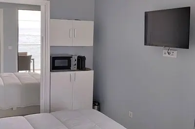 a room with a bed and a microwave on a wall at 'A Bucha' by The Cliff Coast in Paul do Mar