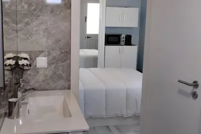 a bathroom with a bed and a sink and a mirror at 'A Bucha' by The Cliff Coast in Paul do Mar