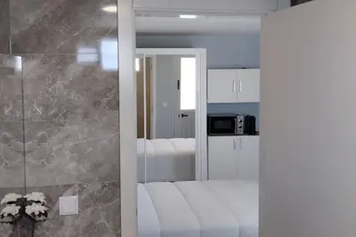 a bathroom with a glass door leading into a room at 'A Bucha' by The Cliff Coast in Paul do Mar