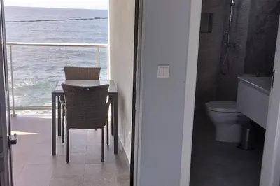 a bathroom with a table and a view of the ocean at 'A Bucha' by The Cliff Coast in Paul do Mar