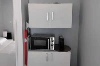 a microwave sitting on top of a white cabinet at 'A Bucha' by The Cliff Coast in Paul do Mar