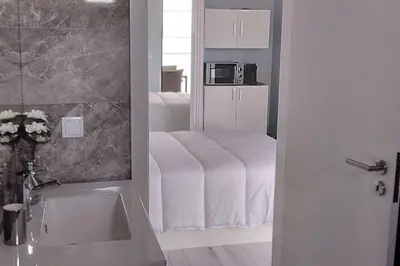 a bathroom with a bed with a microwave in it at 'A Bucha' by The Cliff Coast in Paul do Mar