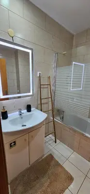 a bathroom with a sink and a bath tub at Serenity Apartment - Free Parking in Santa Cruz