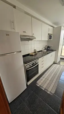 a kitchen with a white refrigerator and a stove at Serenity Apartment - Free Parking in Santa Cruz