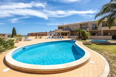 a swimming pool in front of a villa at Casa Keira in Luz