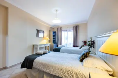a bedroom with two beds and a window at Casa Keira in Luz