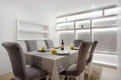 a dining room with a table and chairs and a window at Alegria Dream Home in Funchal