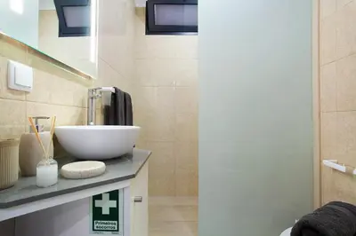 a bathroom with a bowl sink on a counter at Alegria Dream Home in Funchal