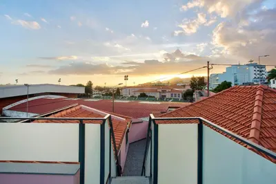 a view of roofs in a city at sunset at Alegria Dream Home in Funchal