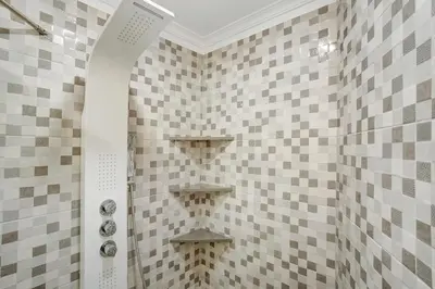 a shower in a bathroom with checkered tiles at Alegria Dream Home in Funchal