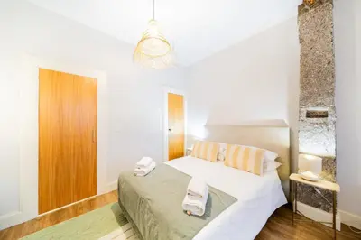 a bedroom with a bed and a chandelier at Casa na Ilha I in Funchal