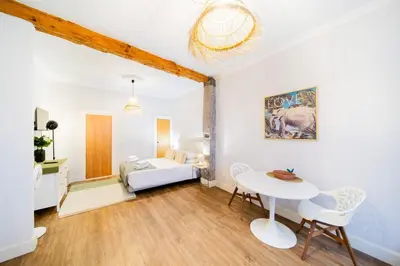 a room with a bed and a table and chairs at Casa na Ilha I in Funchal