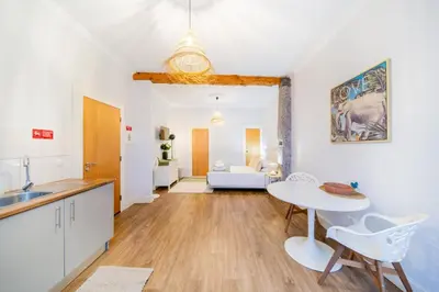 a kitchen and living room with a table and chairs at Casa na Ilha I in Funchal