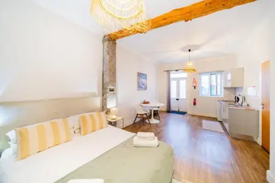 a living room with a bed and a kitchen at Casa na Ilha I in Funchal