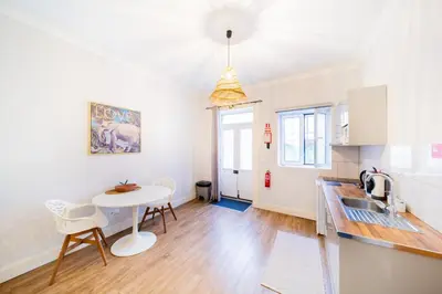 a kitchen and dining room with a table and a small table at Casa na Ilha I in Funchal