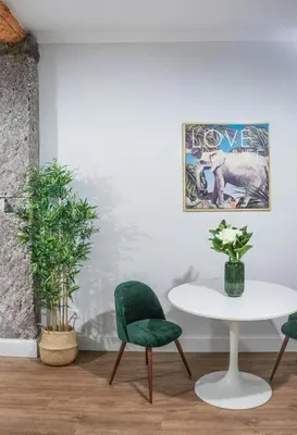 a room with two chairs and a table and a poster at Casa na Ilha I in Funchal