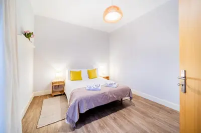 a white bedroom with a bed with yellow pillows at Casa na Ilha II in Funchal