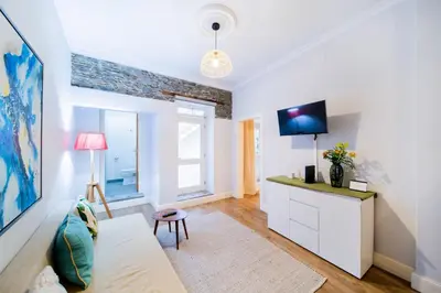 a living room with a couch and a tv at Casa na Ilha II in Funchal
