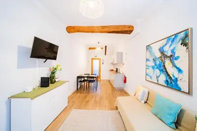 a living room with a couch and a tv at Casa na Ilha II in Funchal