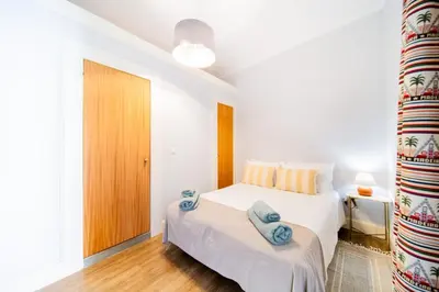 a bedroom with a bed with blue towels on it at Casa na Ilha III in Funchal