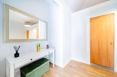 a white dressing table in a white room with a mirror at Casa na Ilha III in Funchal