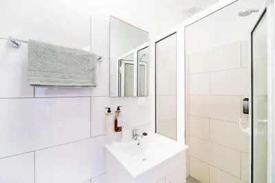 a white bathroom with a sink and a mirror at Casa na Ilha III in Funchal
