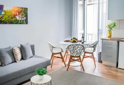 a living room with a couch and a table and chairs at Casa na Ilha III in Funchal