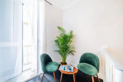a room with three green chairs and a table and a plant at Casa na Ilha III in Funchal