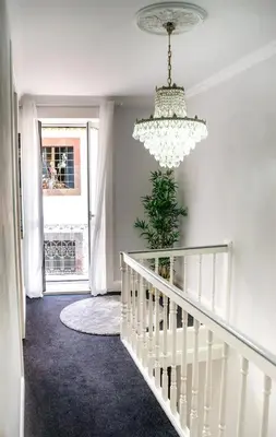 a white staircase with a chandelier in a house at Casa na Ilha III in Funchal